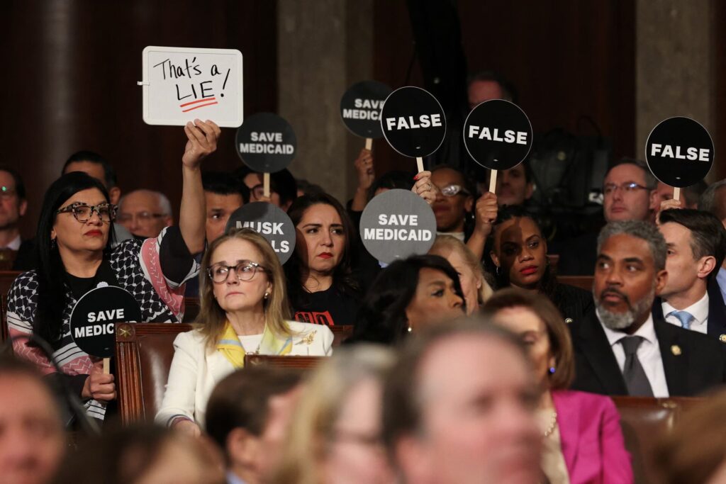 Democrats protest Trump's speech to Congress with disruption, exits and solemn signs 