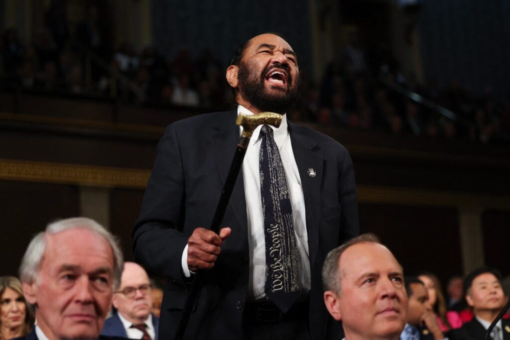 Rep. Al Green of Texas waving his cane and yelling