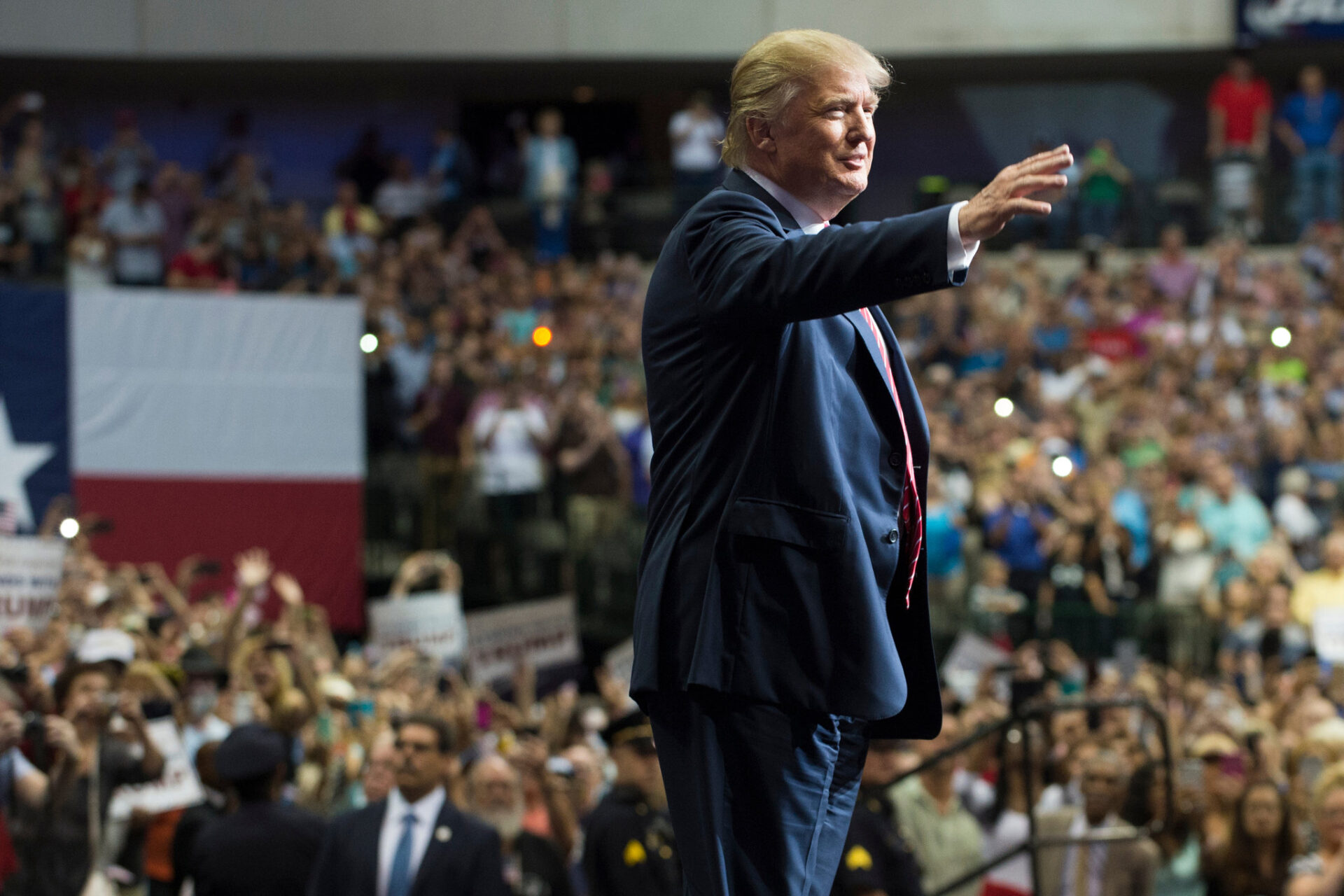 trump speaking confidently at rally with crowd cheering