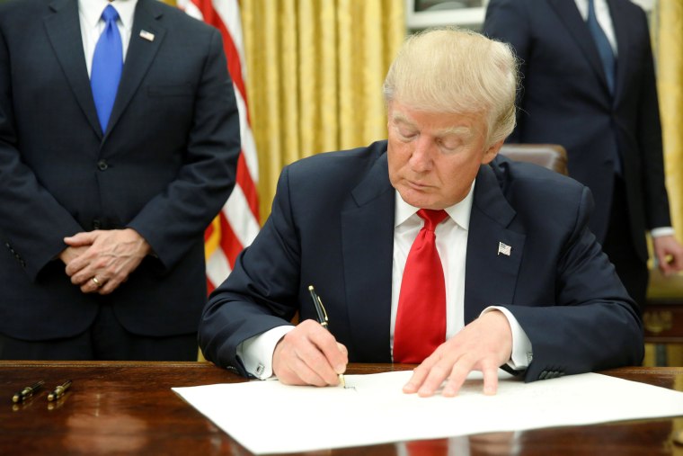 President Trump signing executive order in Oval Office