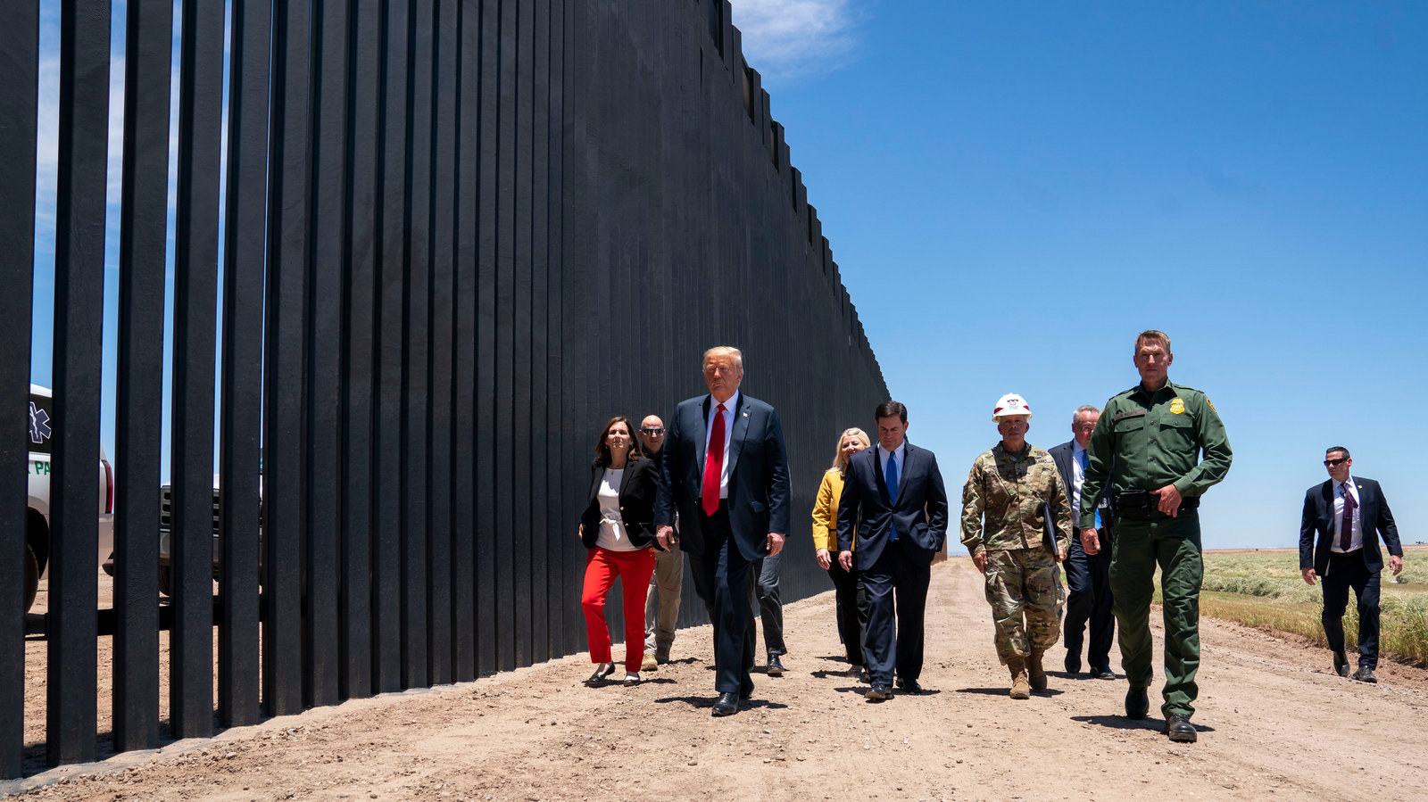 trump walking border wall april 2025 with border patrol and american flags