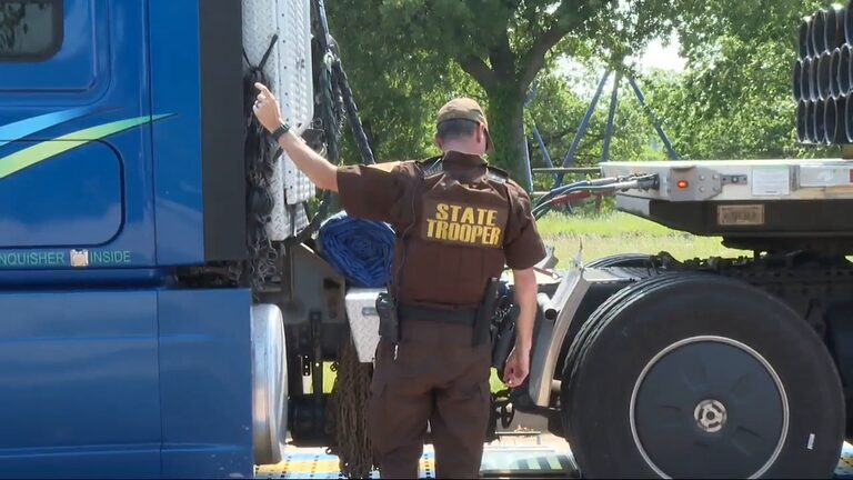 American highway patrol inspecting trucks