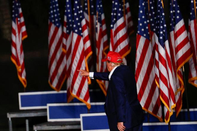 trump standing with american flags 2025