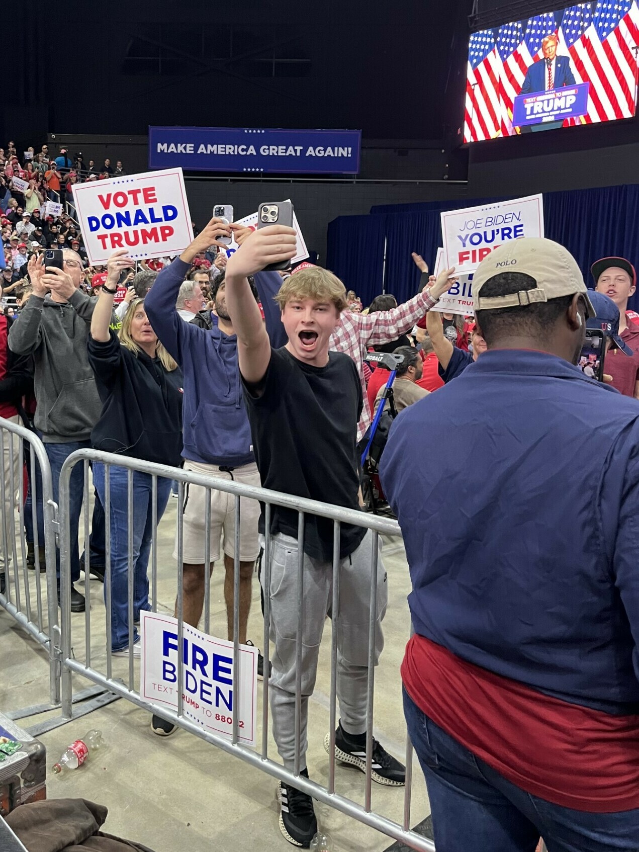 Small American business owners at Trump rally holding Made in USA signs