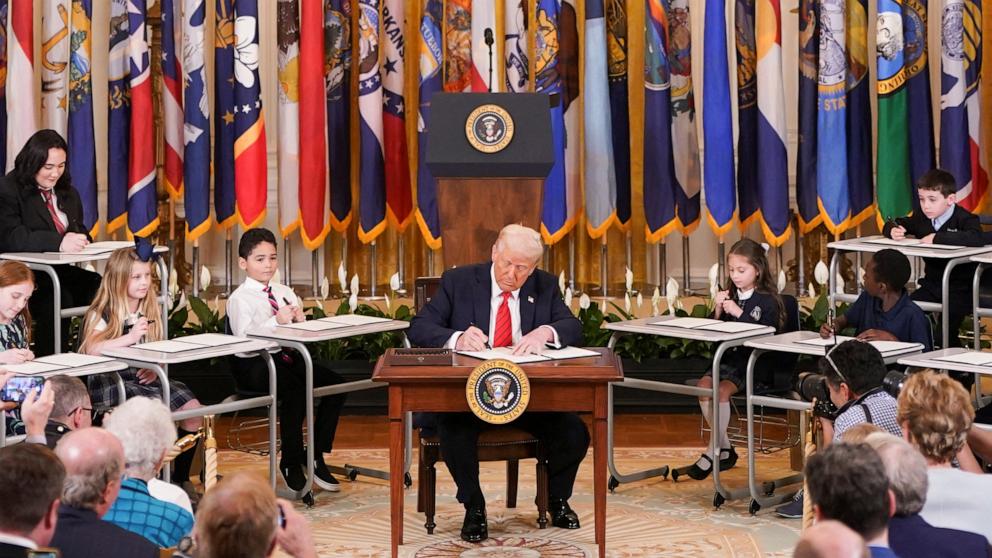trump signing executive order with school children