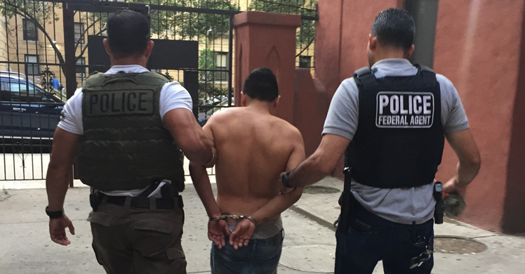 ICE agents detaining a criminal alien