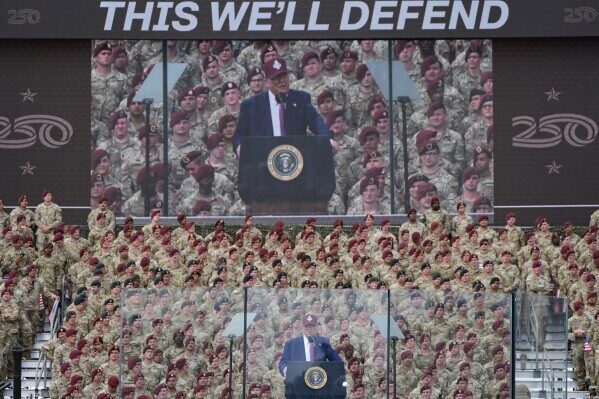 'this we'll defend' banner behind trump at fort bragg speech