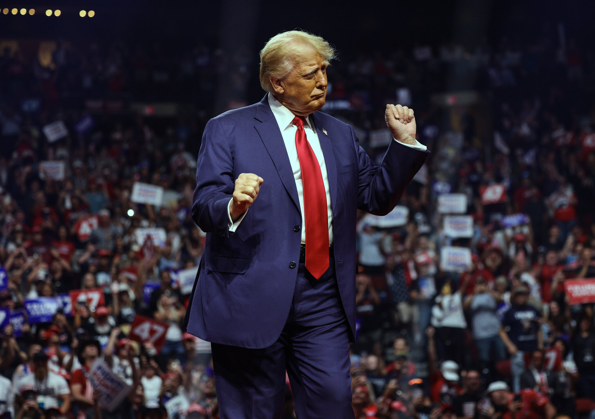 trump celebrating with hands up on stage