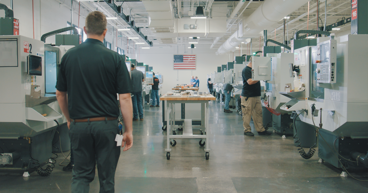Workers assembling advanced military equipment in a U.S. defense manufacturing facility