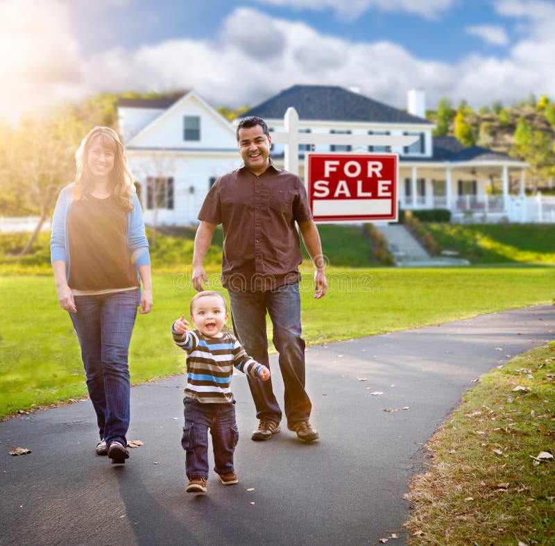 American family walking near a home with a for-sale sign