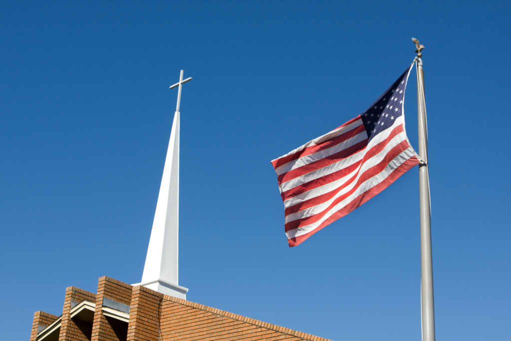 american flag waving in front of church