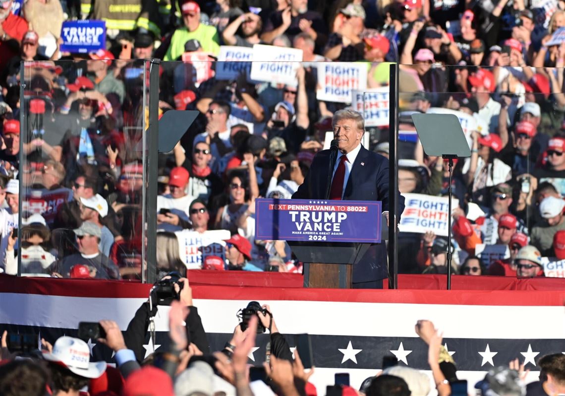 Rallygoers holding "USA" signs in Butler, July 2024