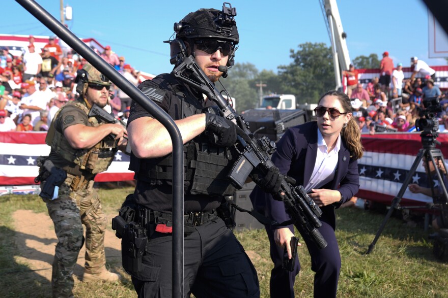 Secret Service command vehicles and armored agents at a Trump rally post-Butler incident