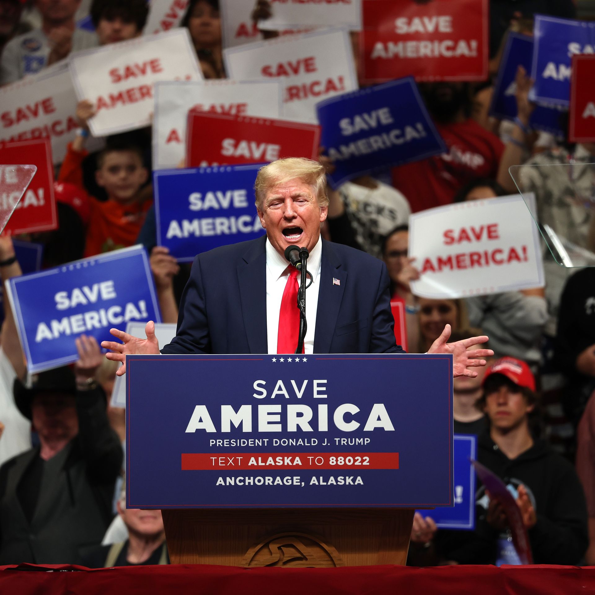 donald turmp rally with 'america first' signs