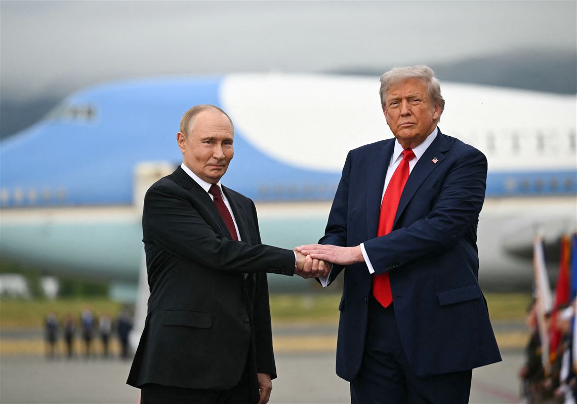 trump and putin shaking hands in alaska