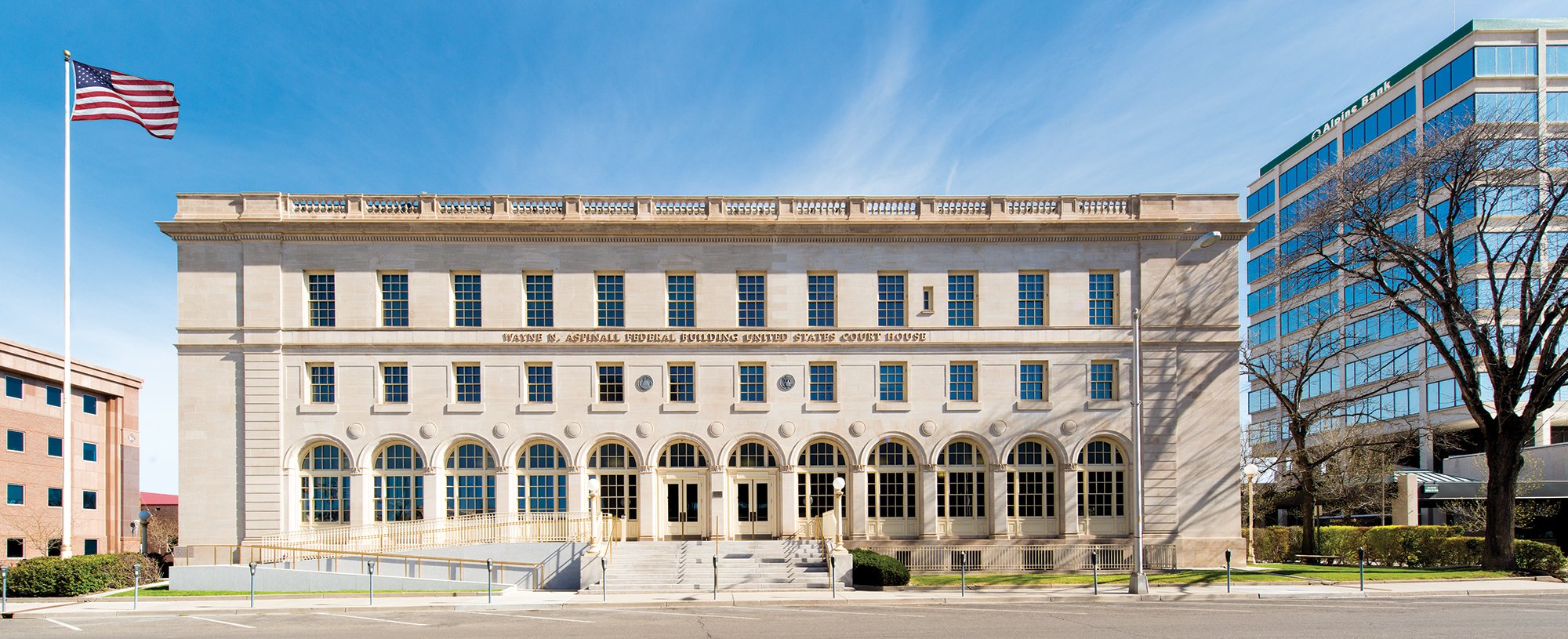 A federal courthouse building with american flag