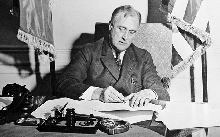 President Franklin D. Roosevelt signing a document