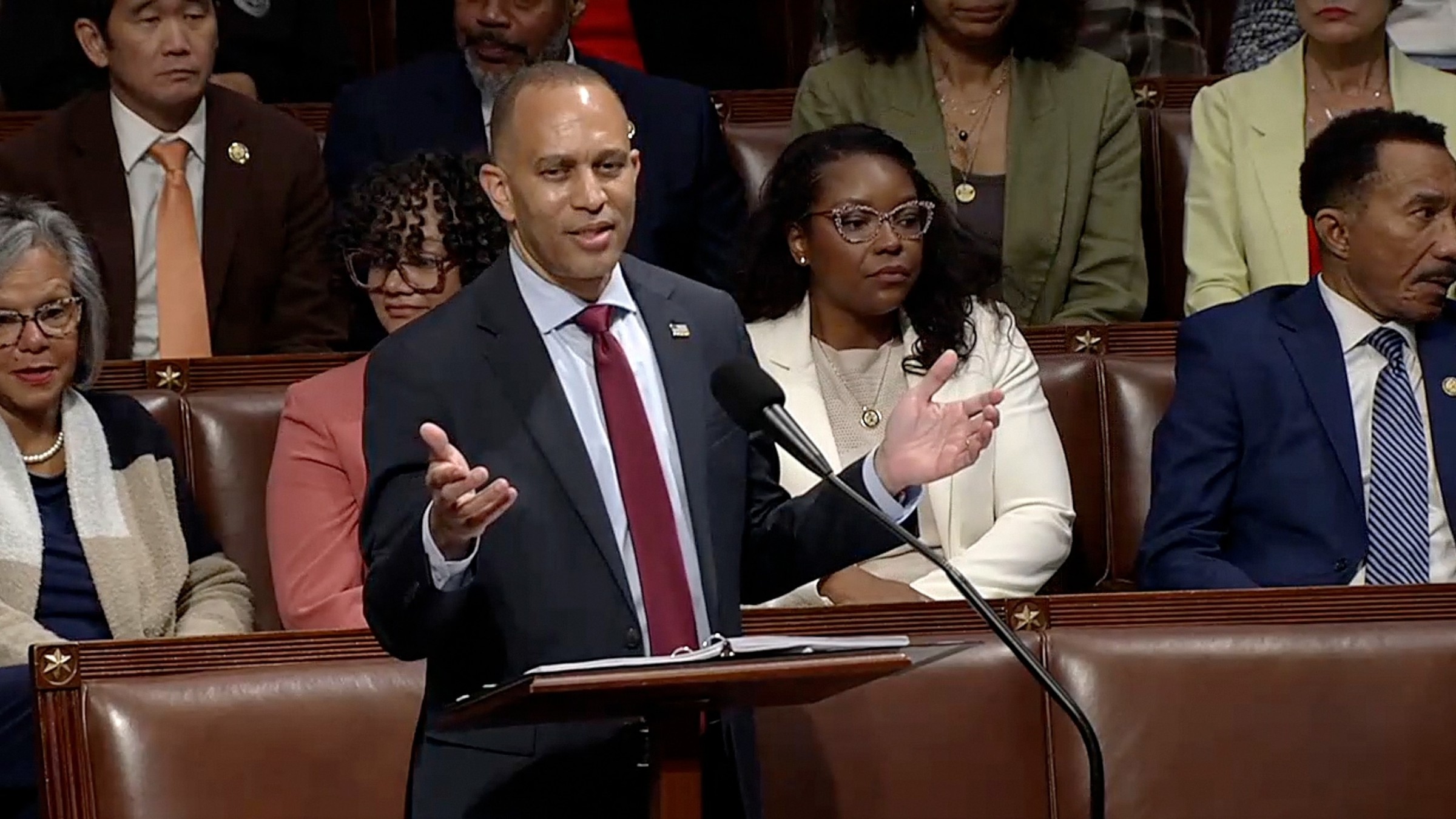 House Minority Leader Hakeem Jeffries speaking at a podium