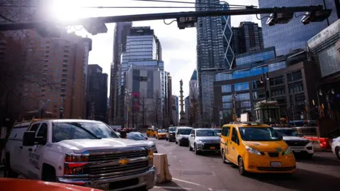 traffic on a New York City street with a congestion pricing camera
